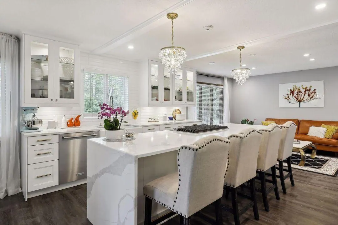 Kitchen island with cream upholstered stools in the Burnsville home