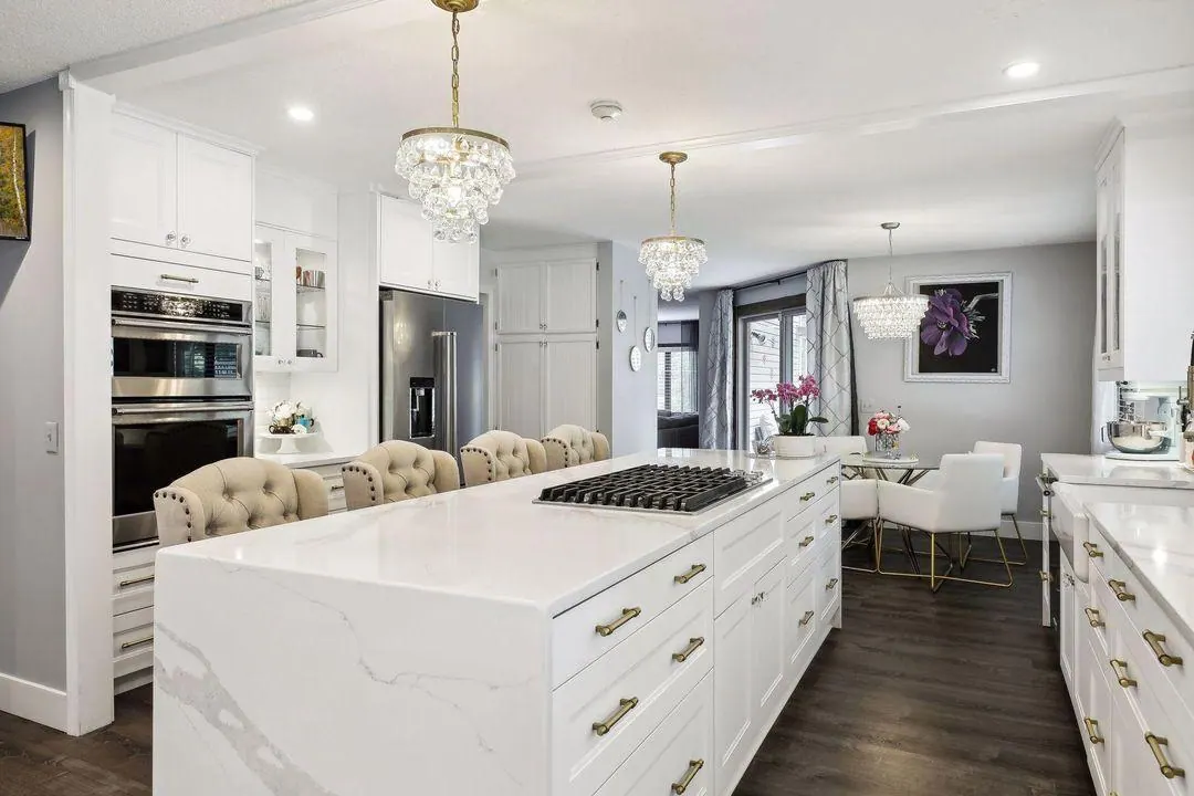 Kitchen with a marble island, double ovens and glass-front cabinets in the Burnsville home