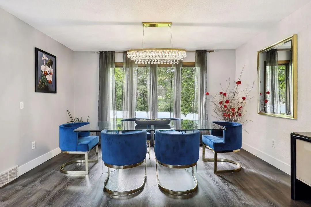 Dining room with blue velvet chairs and a chandelier