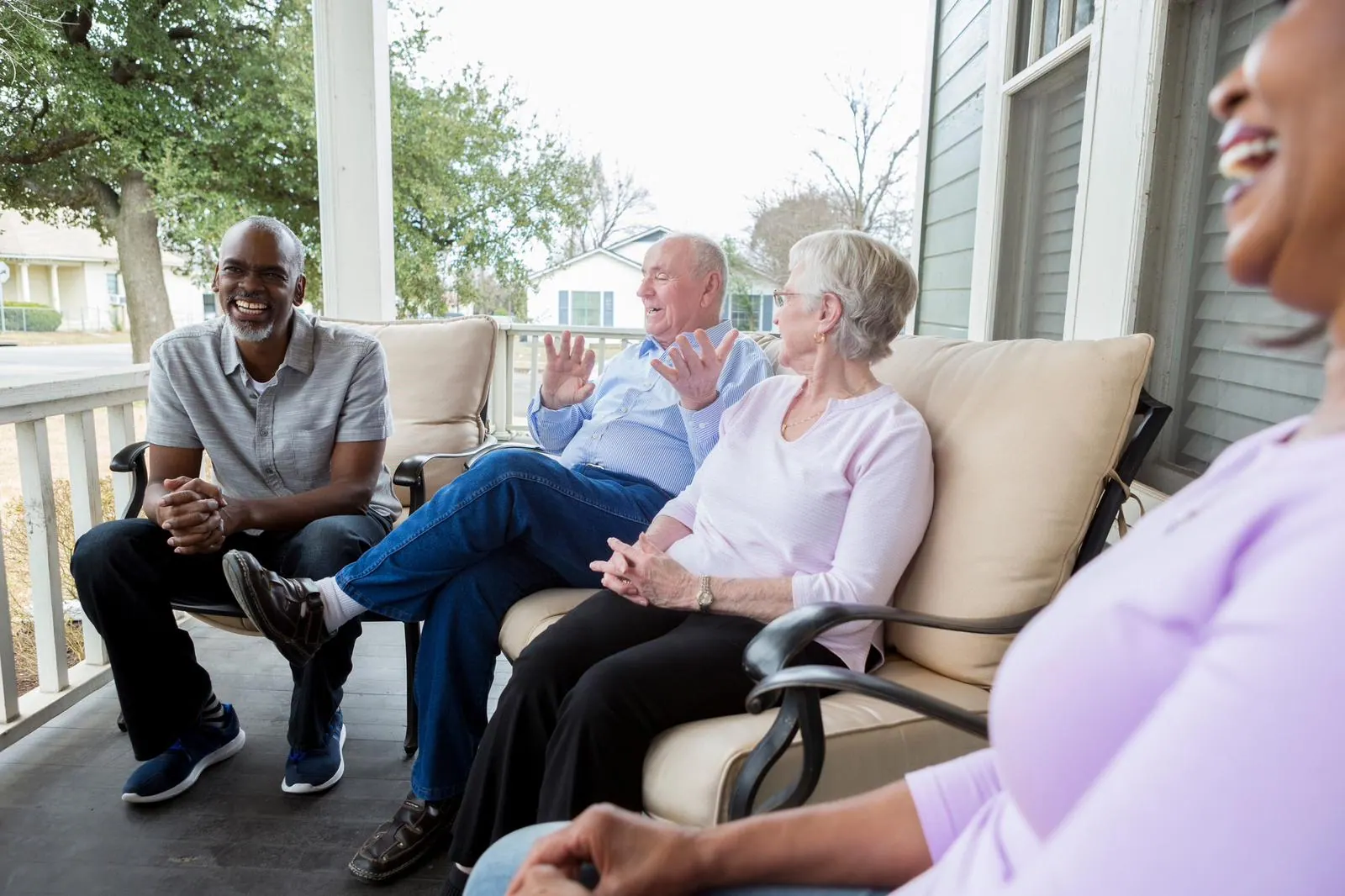 Residents relaxing together on the porch at Twin Cities Living Assistance