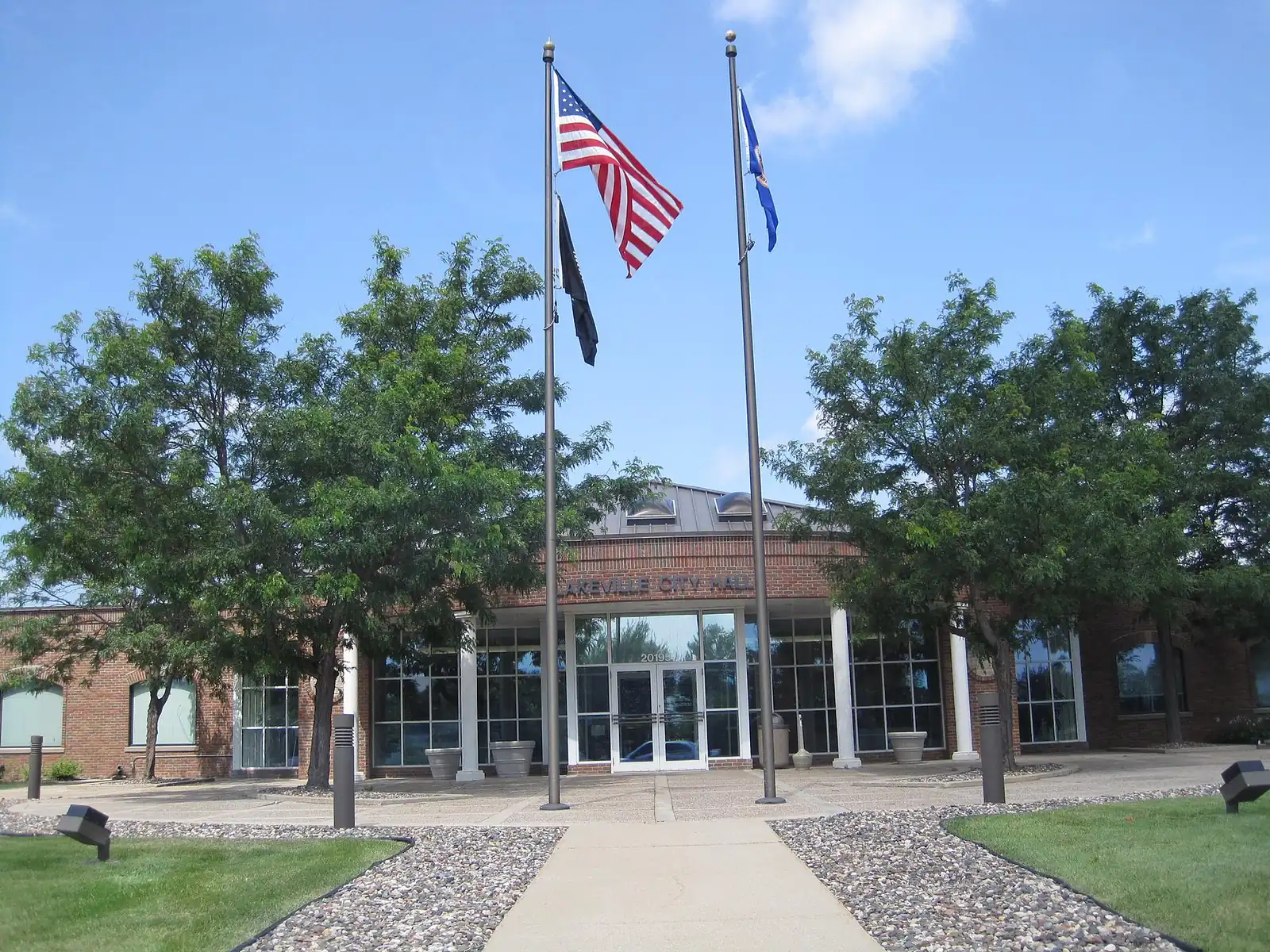 Lakeville City Hall with flags flying out front on Holyoke Avenue, Lakeville, Minnesota