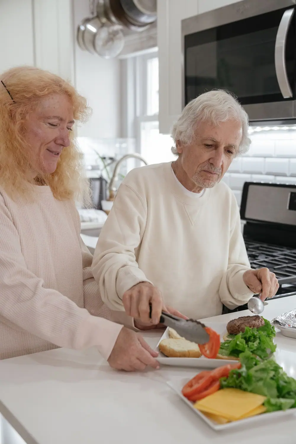 Two older women preparing a vegetable plate together at a kitchen counter (representative photo)